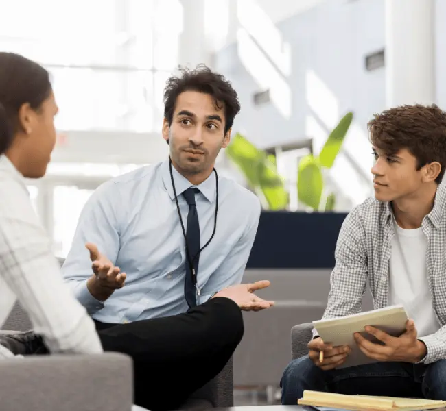 Overseas education consultant in a counselling session with students discussing university applications
